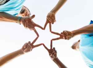 group of people doing star handsign